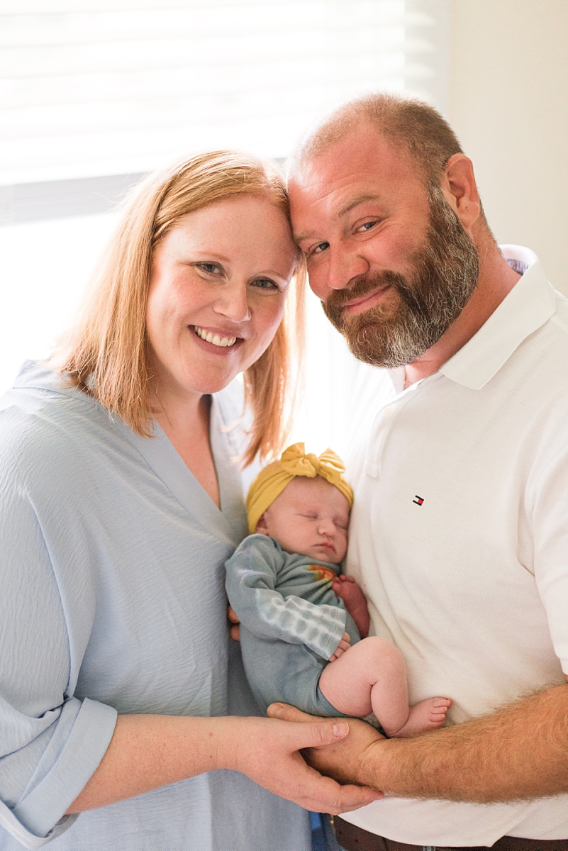 parents hold daughter during Lifestyle Newborn Session
