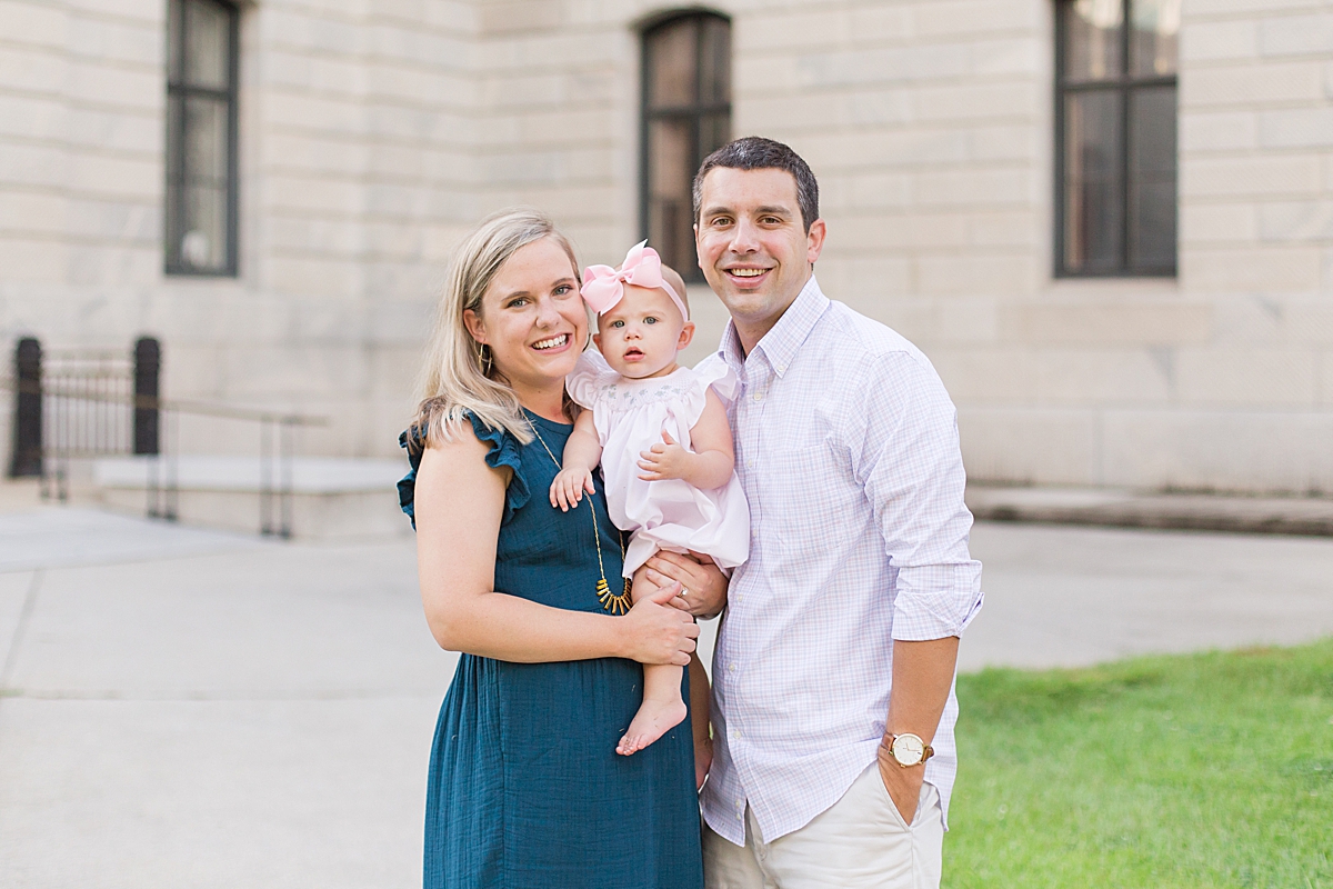 Mom and dad hold their one-year old girl during family portraits in Columbia SC