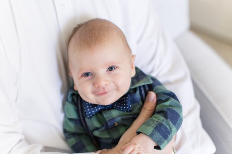 SC newborn boy looks at camera and smiles