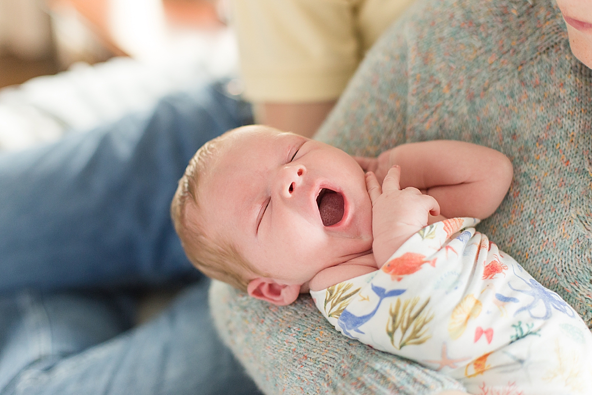 baby yawns during newborn photos with nautical themed nursery
