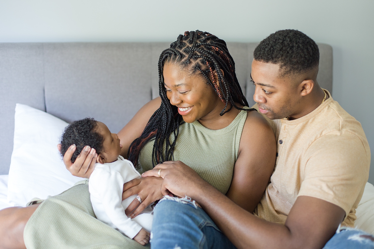 parents smile at new baby boy during lifestyle newborn session in Columbia SC