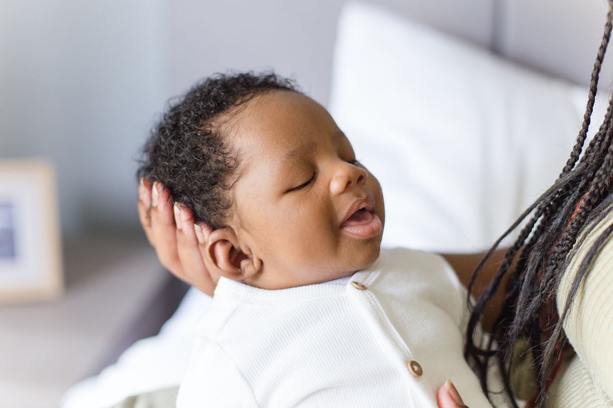 baby boy smiles during lifestyle newborn session