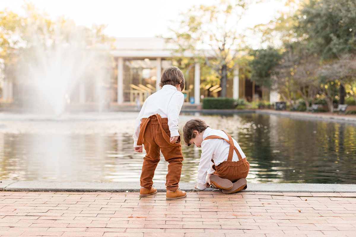 brothers play near water fountain at USC Horseshoe