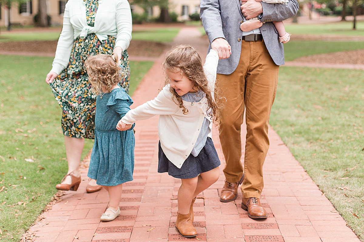 daughter plays during family photos in South Carolina
