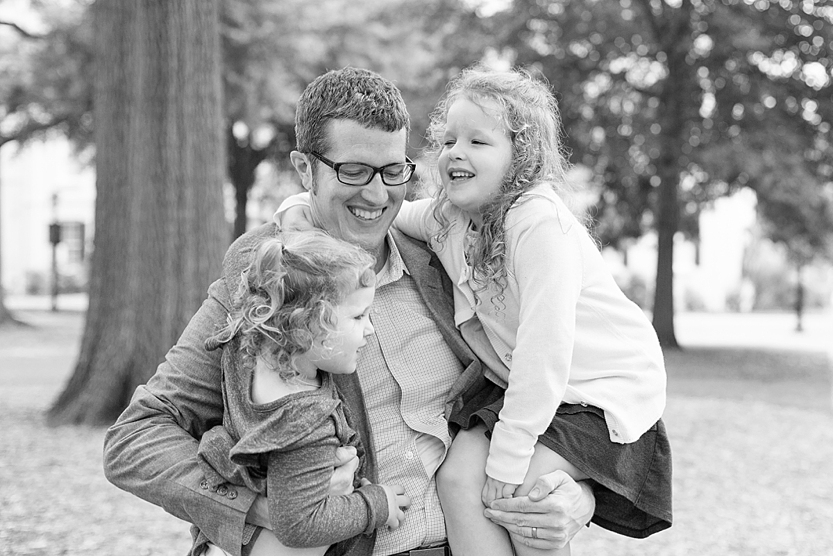 dad holds daughter during Fall Family Session at the USC Horseshoe