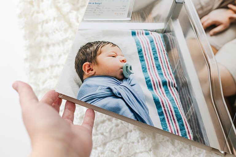 photo showing image from a fresh 48 hospital newborn session printed on the page of a custom newborn album created by Nicole Watford, a newborn photographer in Columbia SC